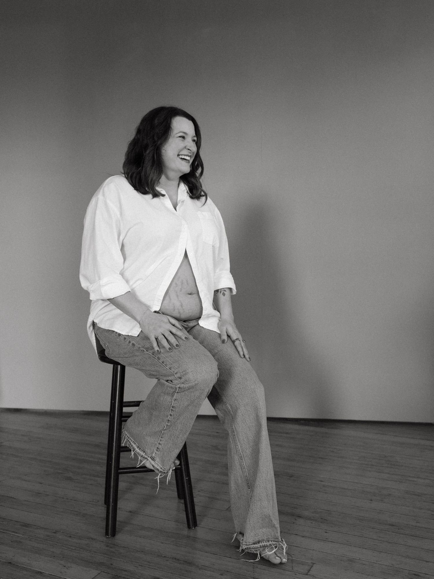 Black and white photo series showing a person in a white shirt and jeans seated on a wooden chair against a plain wall.