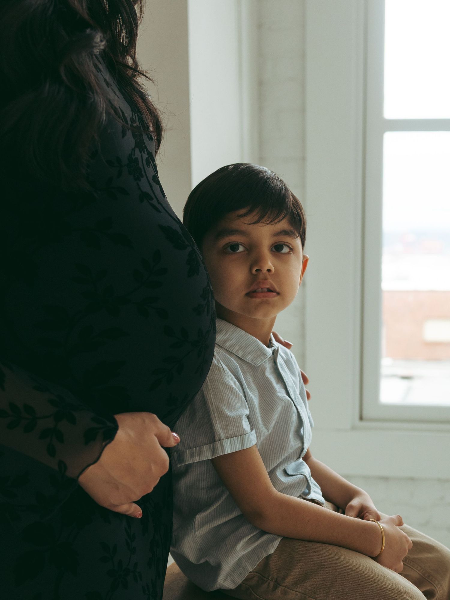 Candid family photos capturing playful interactions in a bright indoor setting.