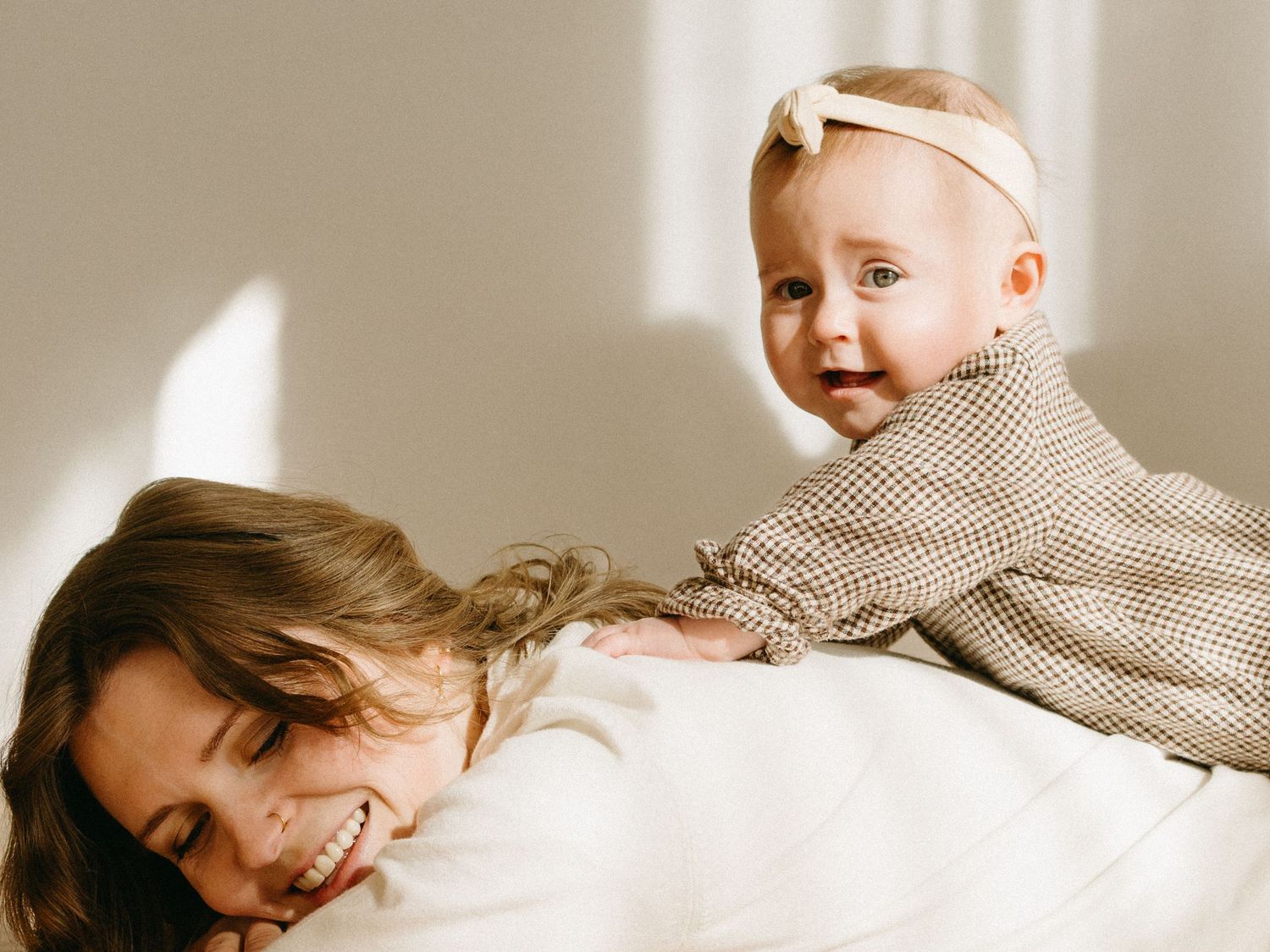 Soft, natural light family portraits with gentle shadows and neutral tones.