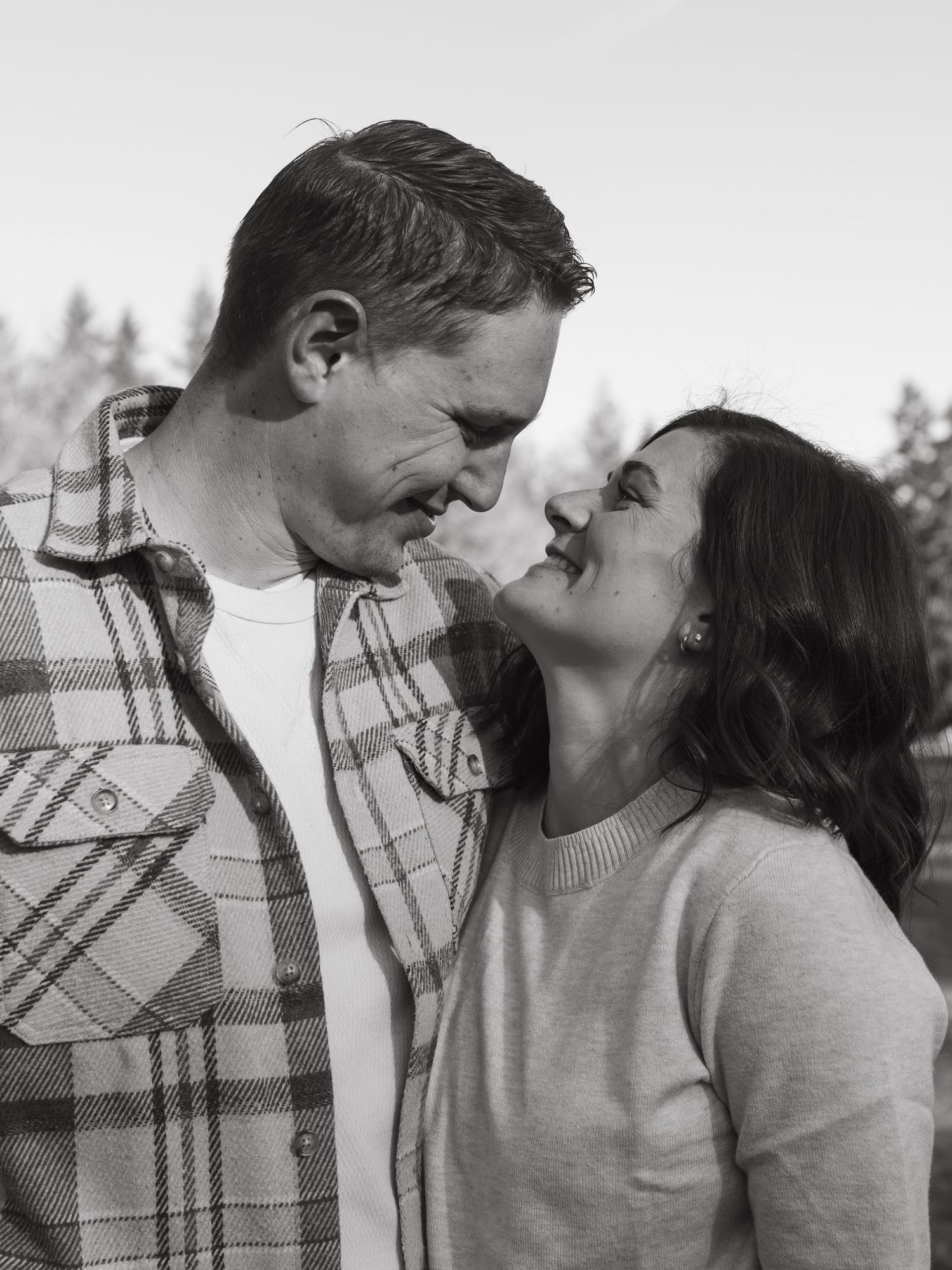 A romantic black and white photo series showing tender moments between a couple in casual attire.
