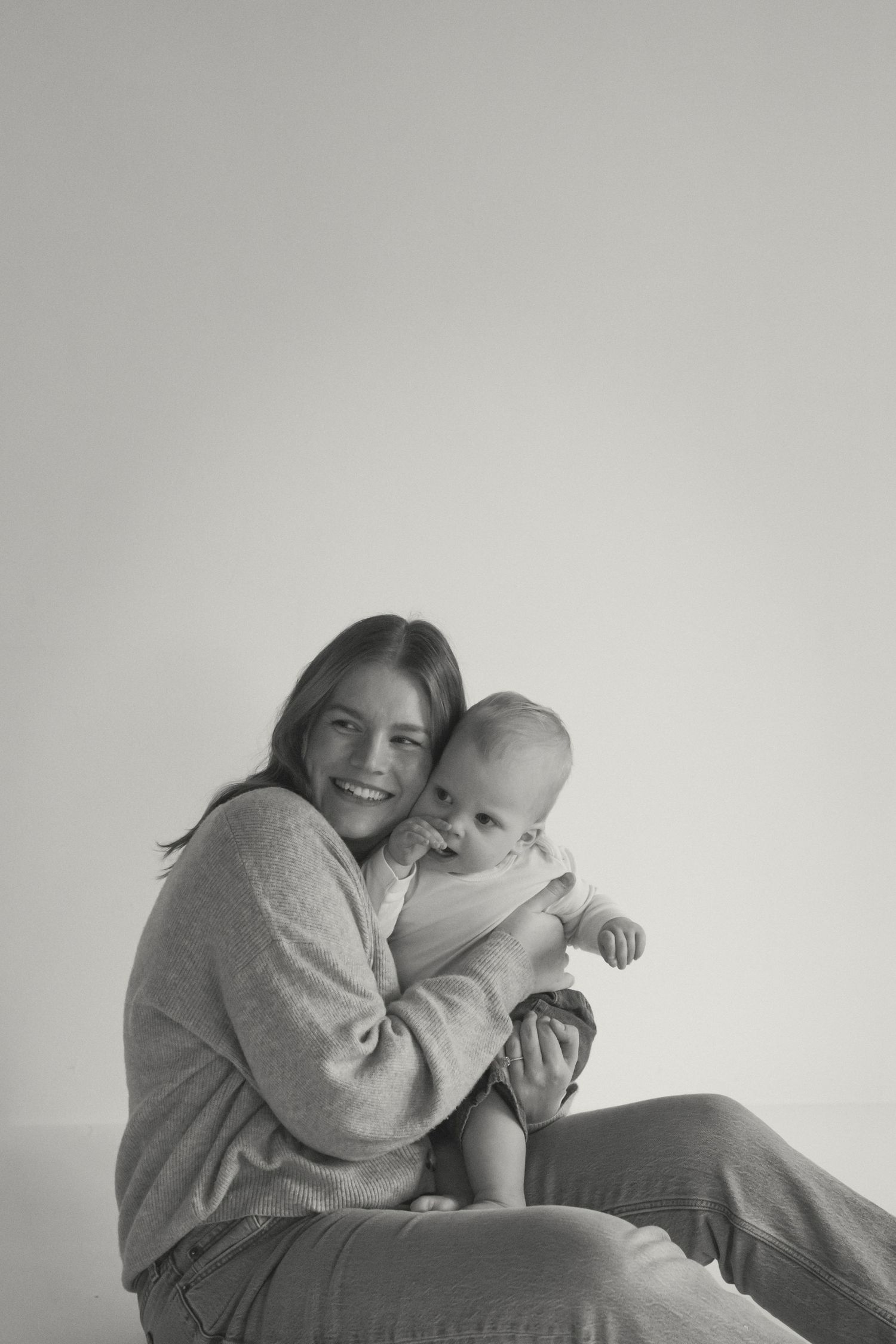 Heartwarming sequence showing playful interactions between parent and infant on light background.