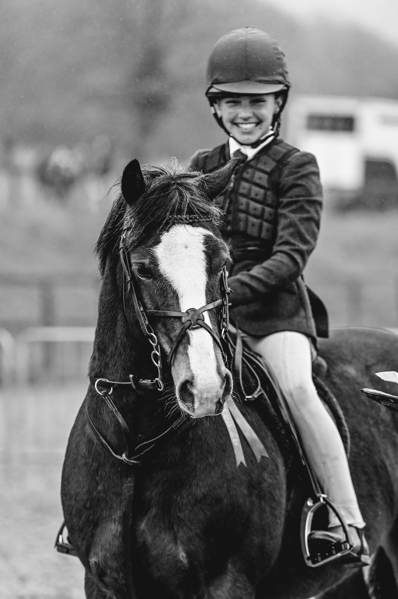 Black and white photograph of riders on horses during an equestrian competition.