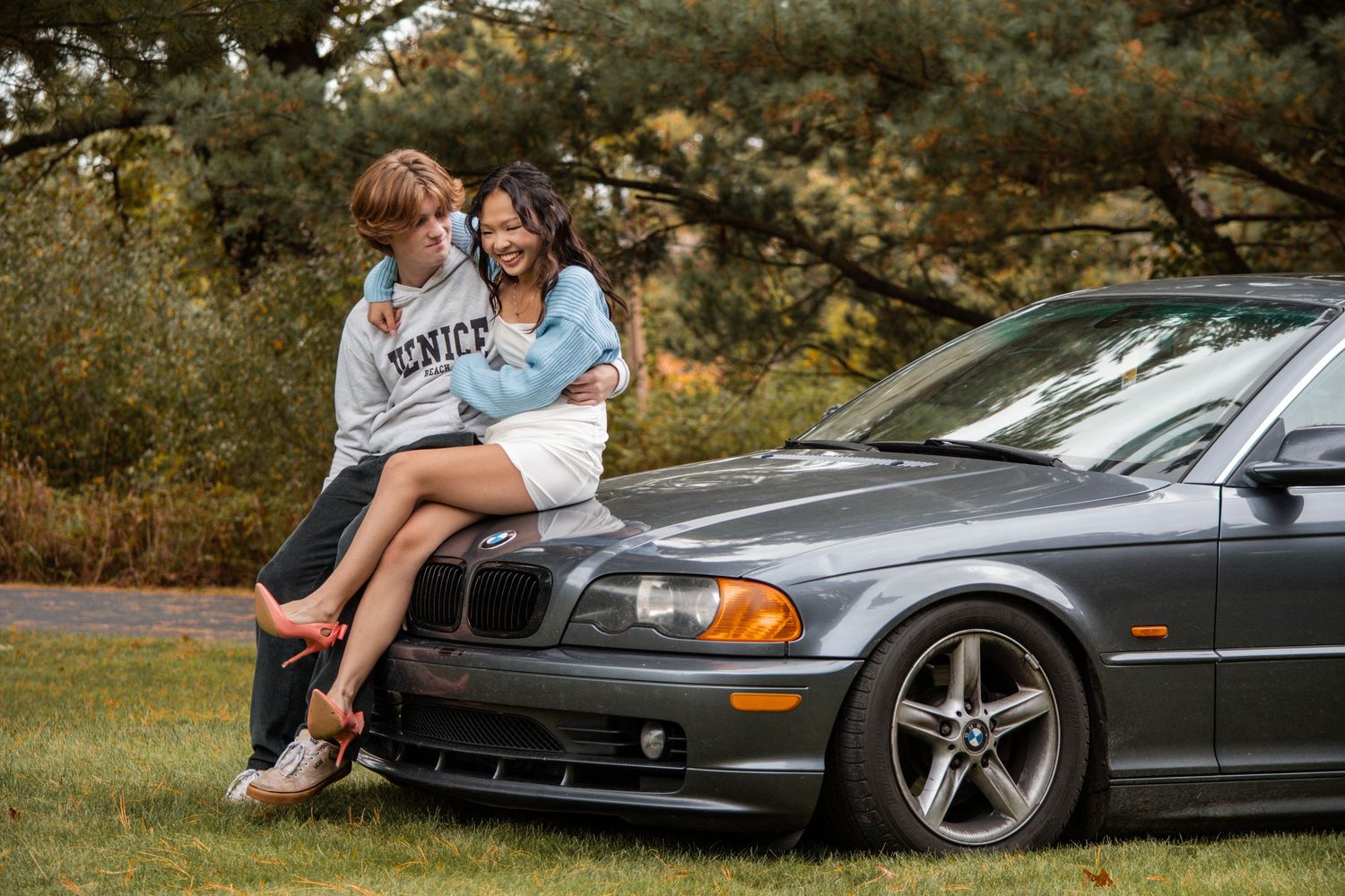 Fall Portrait of a Girl with her boyfriend on a car