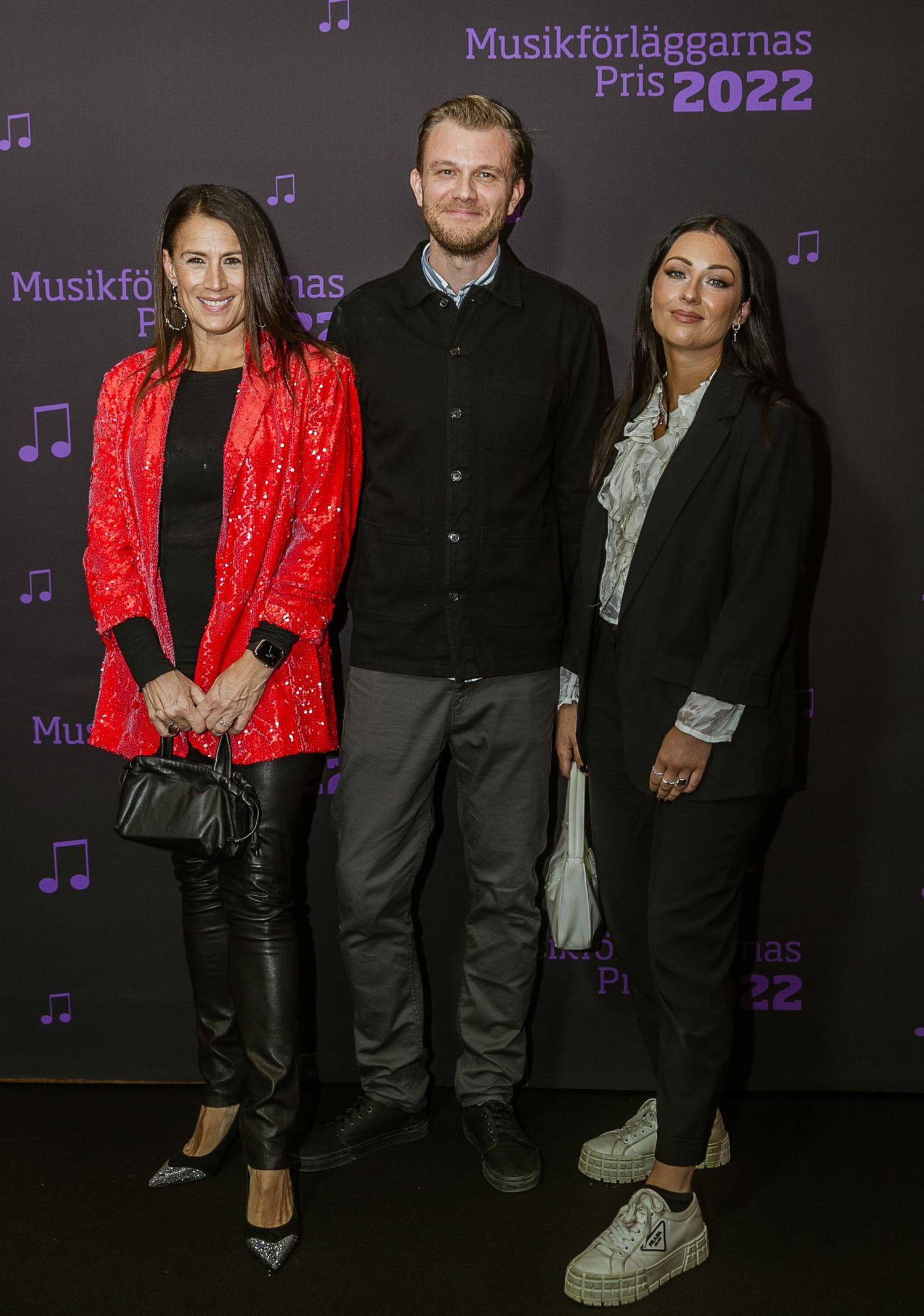 Music industry event with purple lighting and branded backdrop.