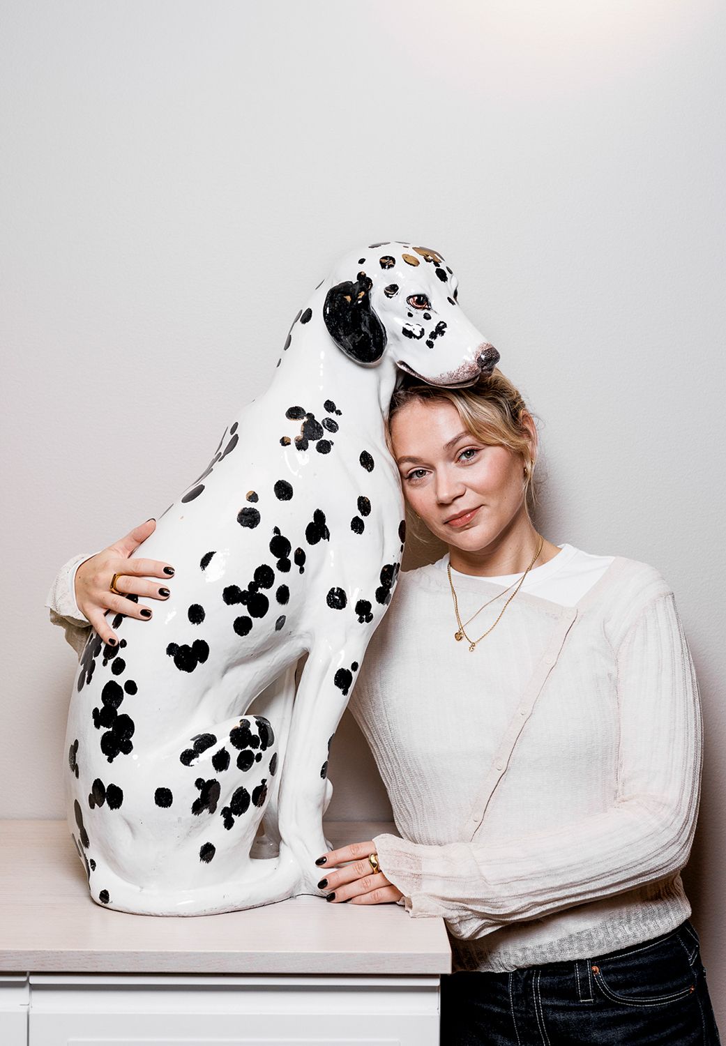 White spotted Dalmatian plush toy posed against white background in studio setting.