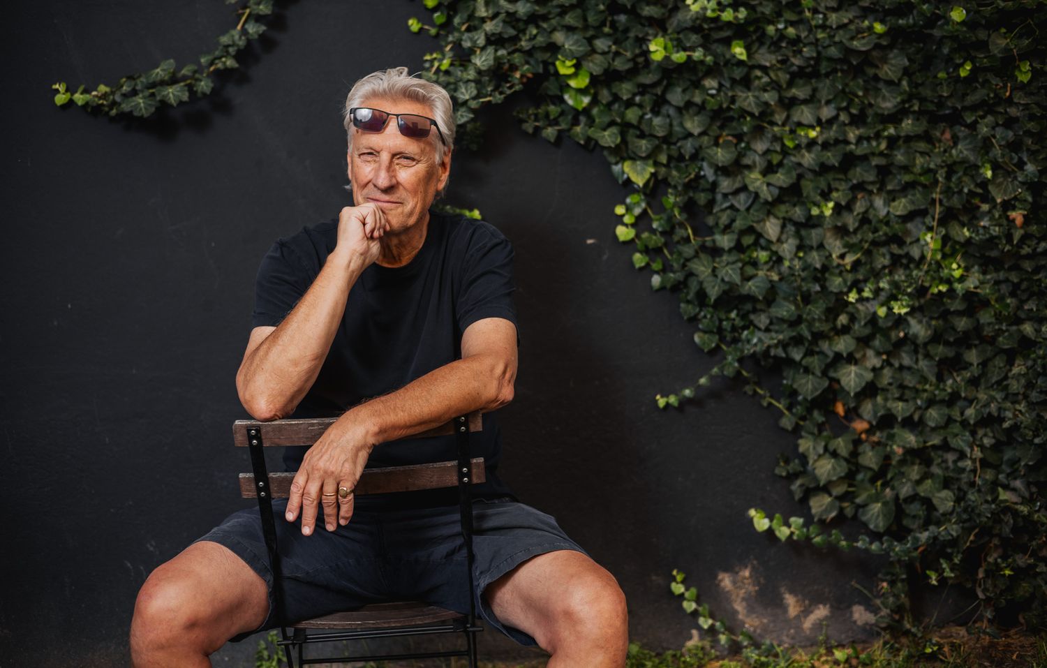 Series of outdoor portraits against dark wall with climbing ivy.