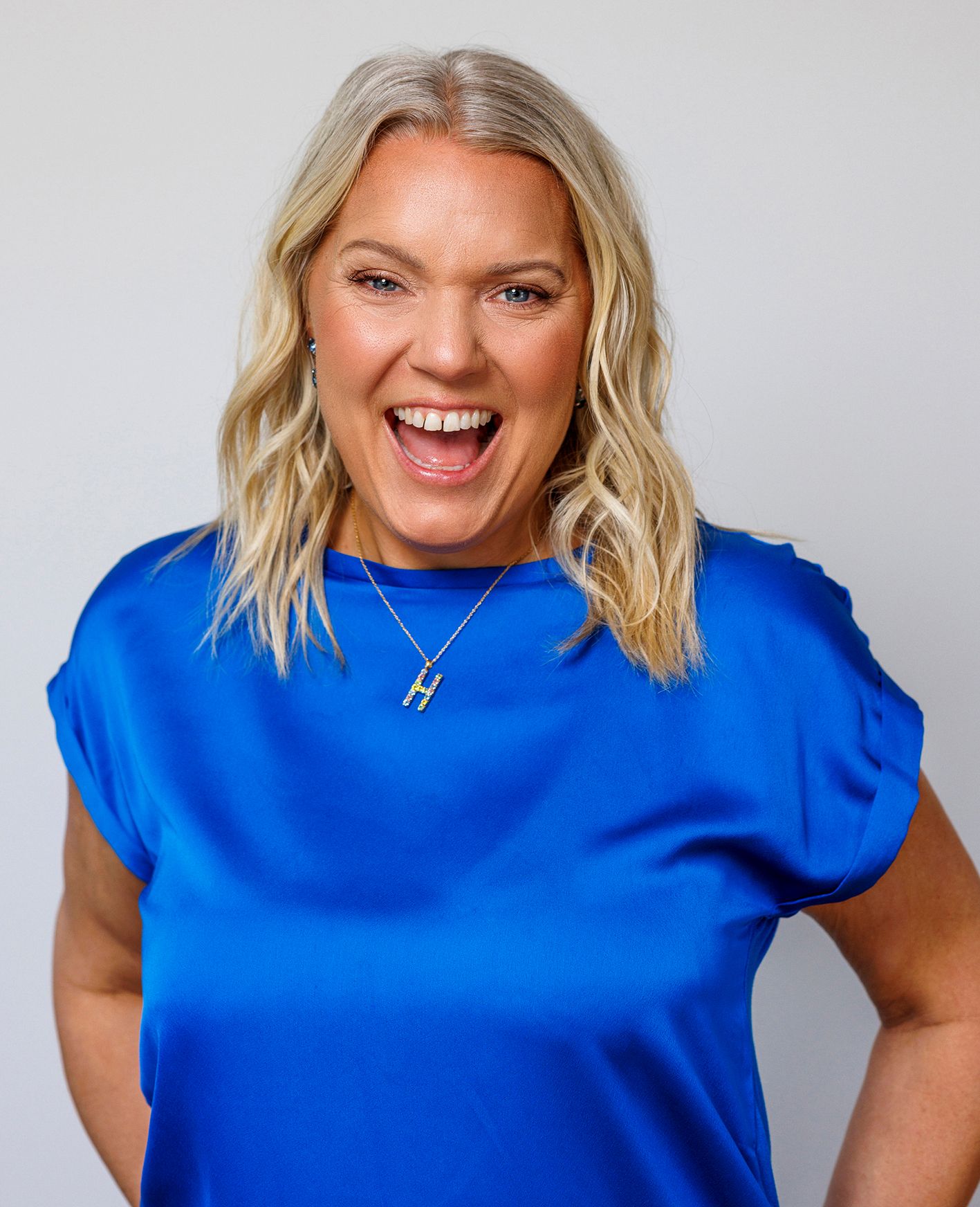 Series of expressions in a bright blue top against white background.