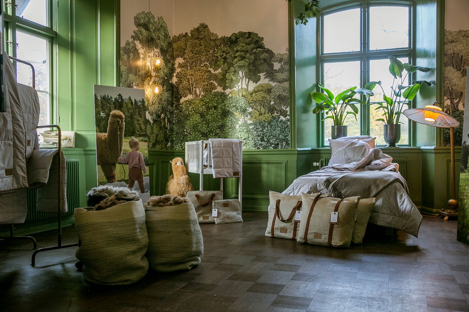 Interior room with green walls, large windows, and comfortable seating areas.