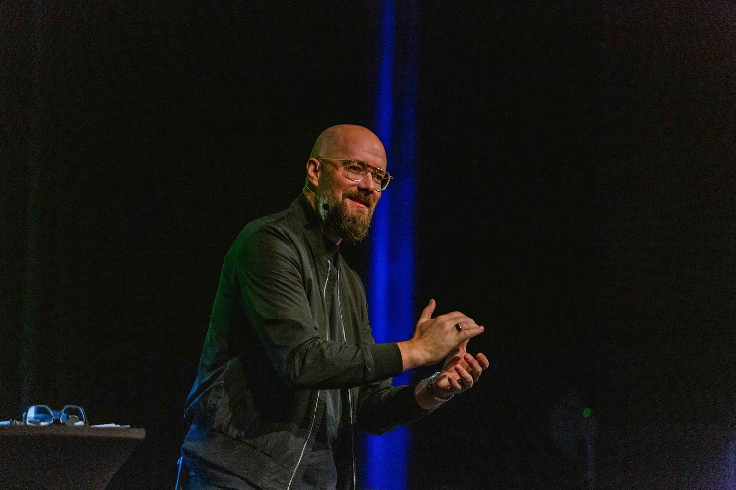 Stage lit with blue lighting during a professional presentation.