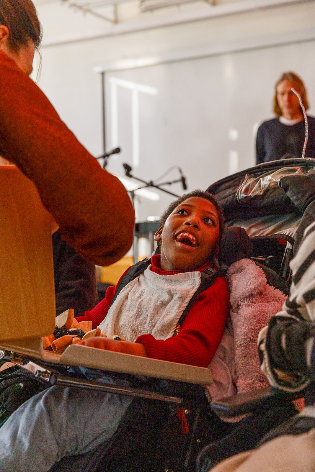 Person in red clothing expresses joy while participating in an interactive session.