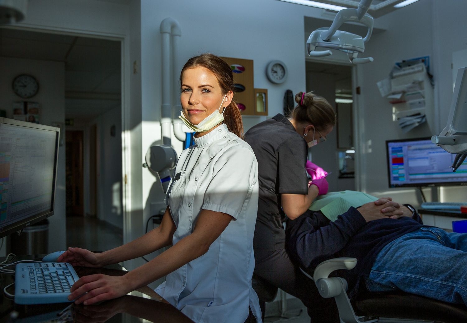 Medical professionals working at computer stations in modern healthcare facility.