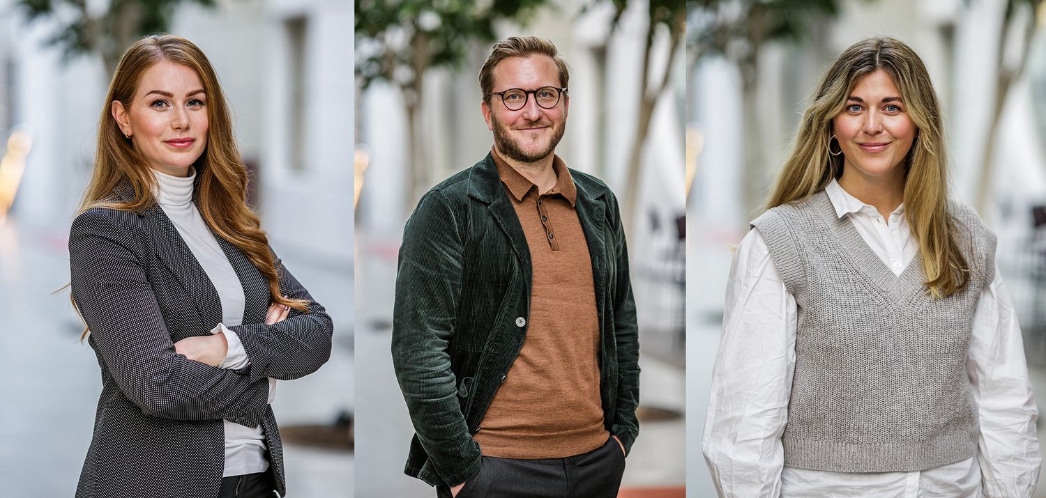Teammedlemmar i affärsklädsel fotograferade mot vit bakgrund