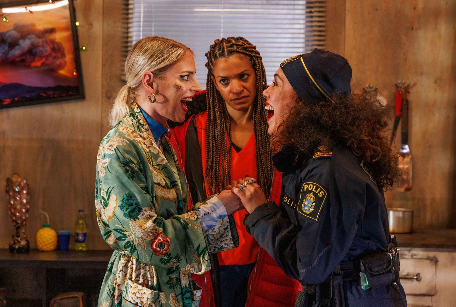 Intimate group scene in warm lighting showing casual conversation.