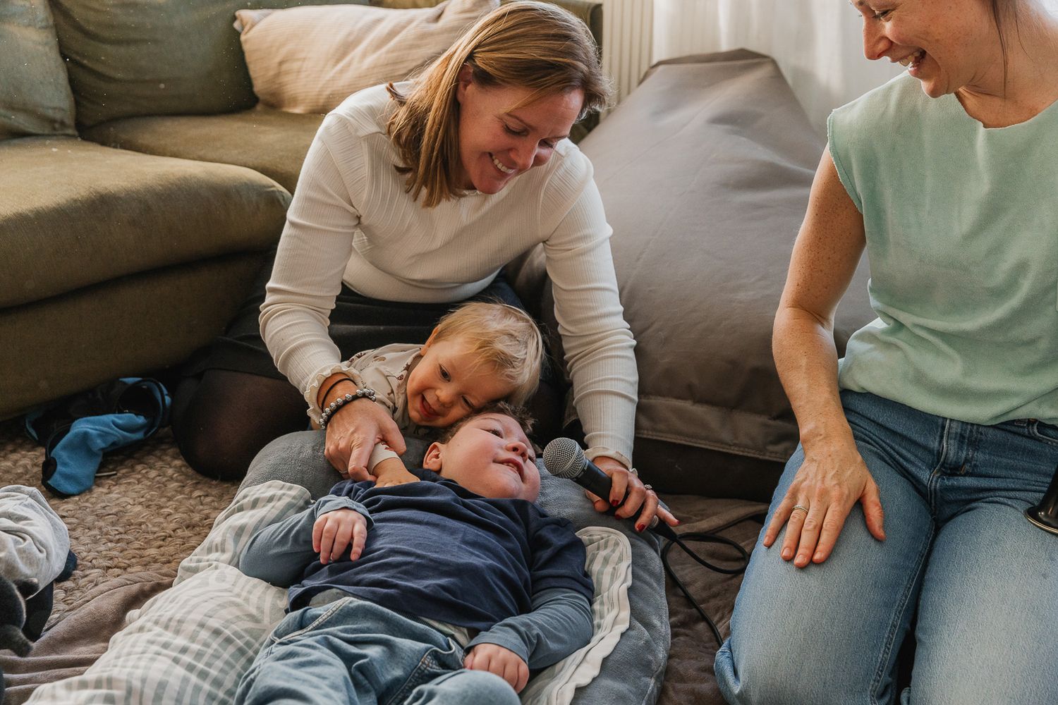 People interact during a casual therapy or sensory session on comfortable furniture.