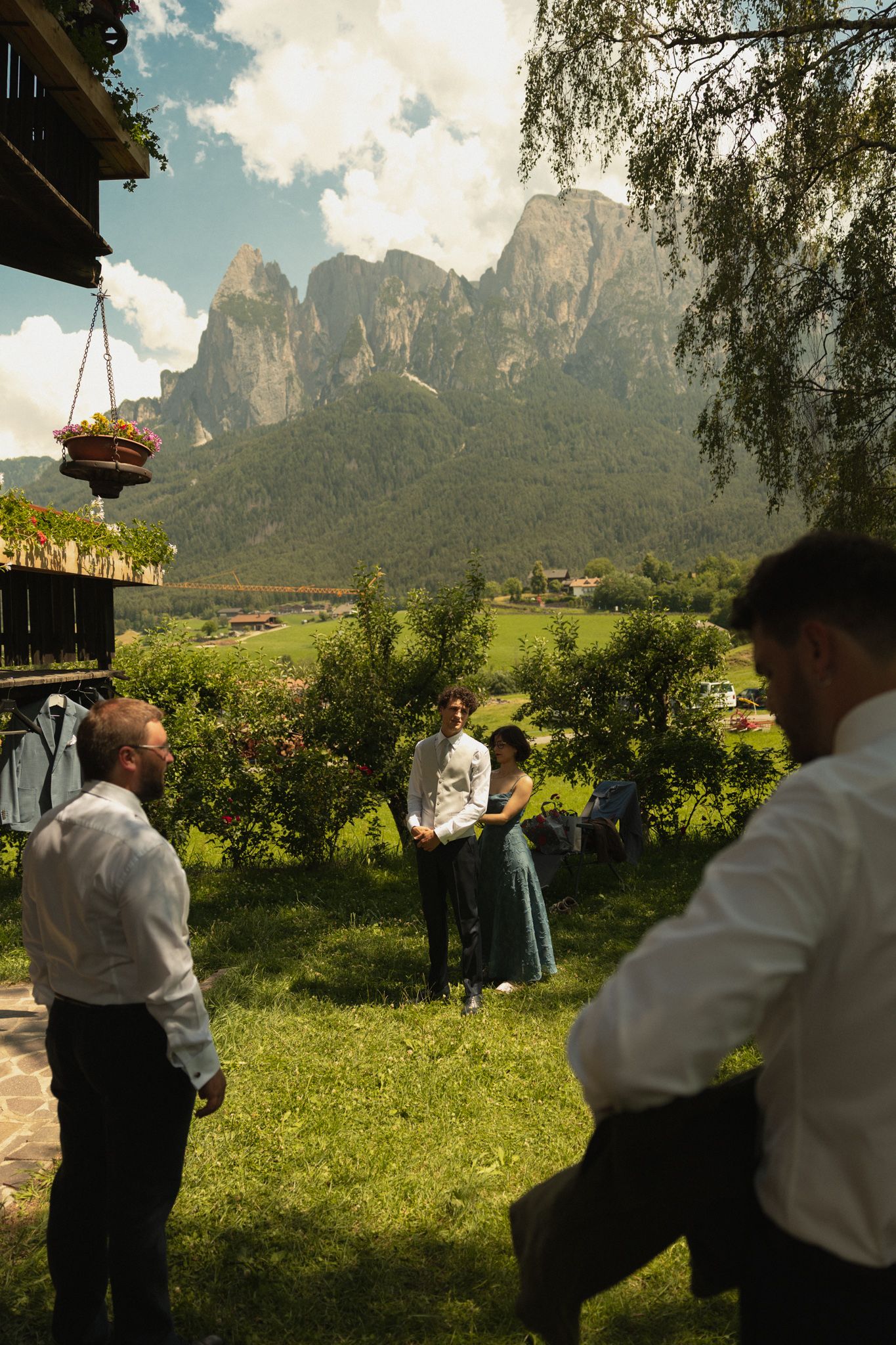 Groom preparation with Sciliar mountains behind him, Dolomites