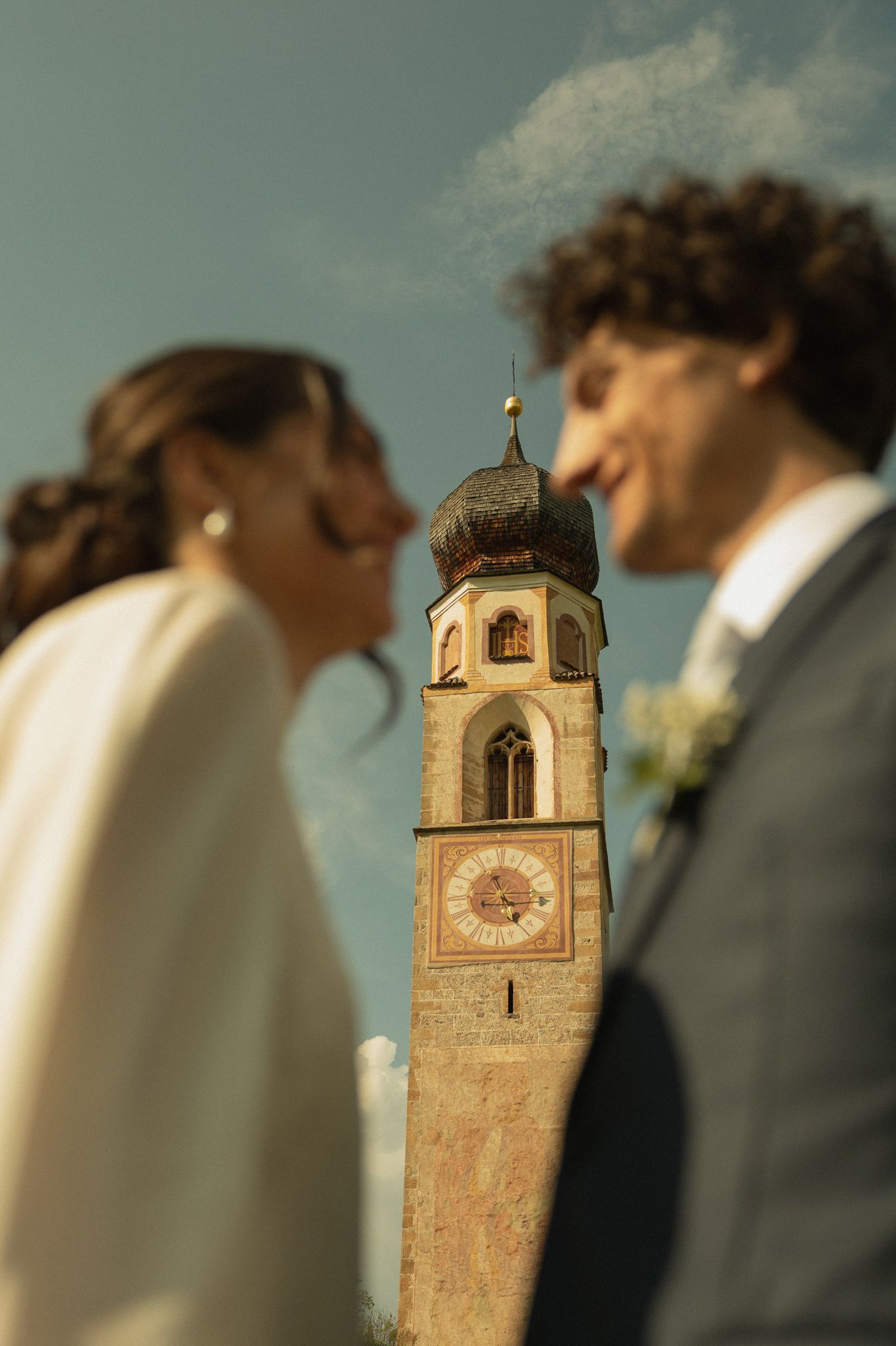 Couple outside San Costantino church, Alpe di Siusi, Dolomites
