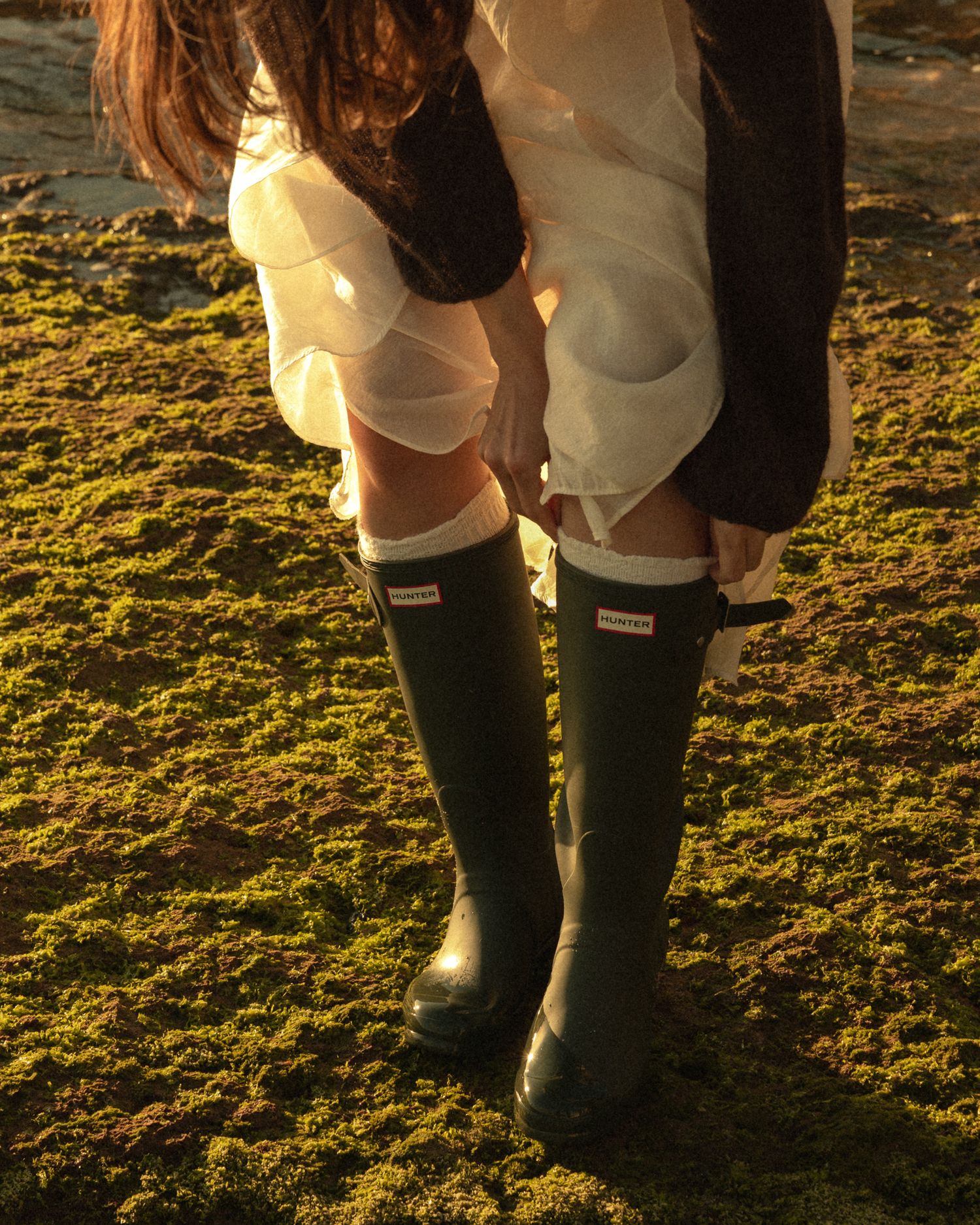 Detail shot of Hunter boots during a couple session on a beach outside Lisbon
