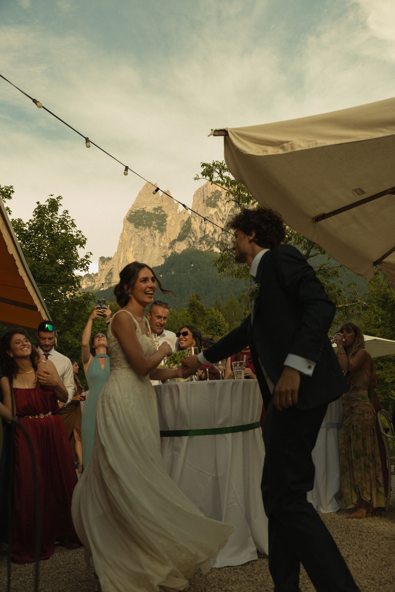 Golden hour bride and groom dance with Scillar in the background, Dolomites