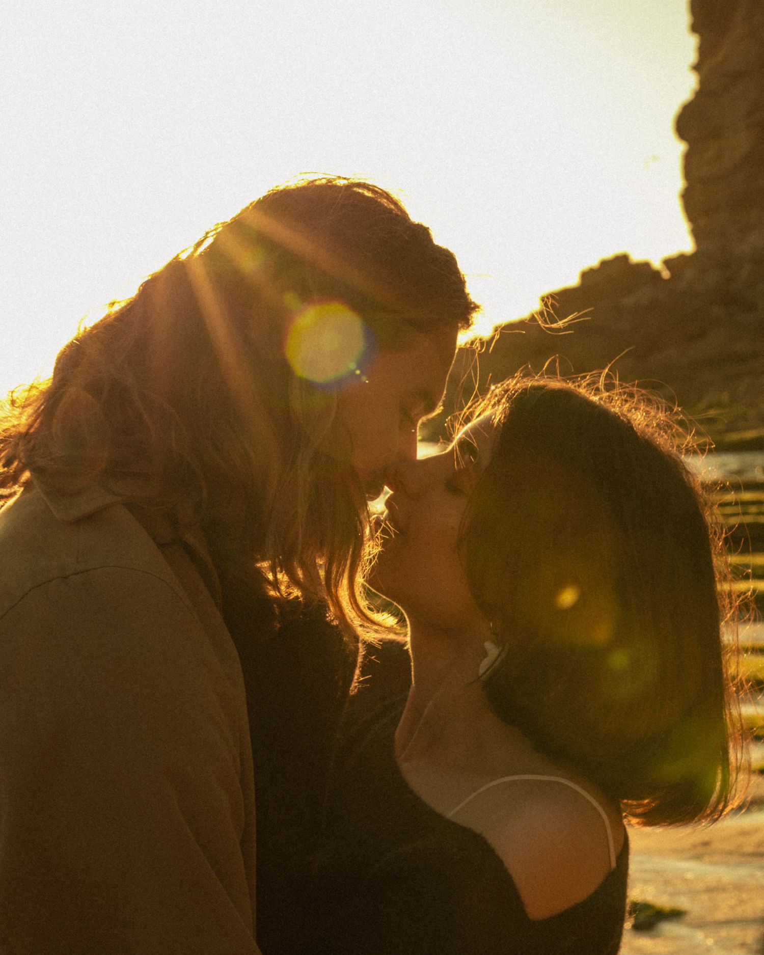 Golden hour couple portrait on the Lisbon coastline