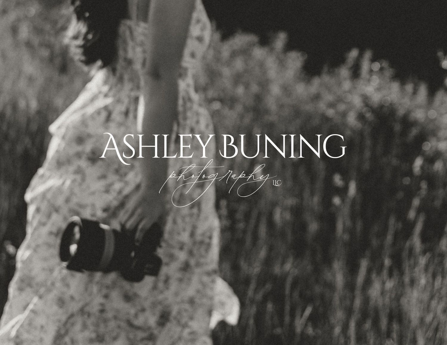 Ashley Buning Photography logo overlaid on a black and white image of a woman in a floral dress holding a camera.