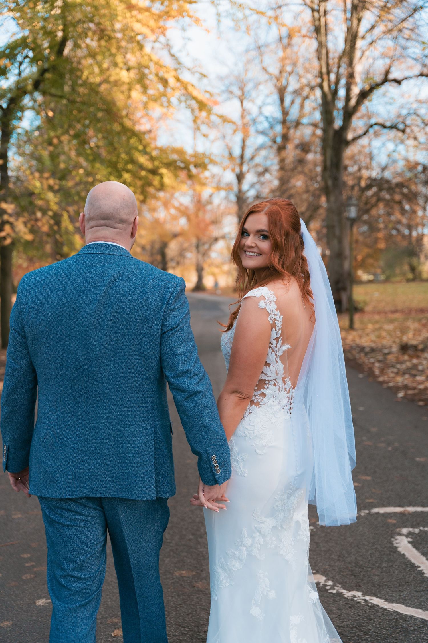 Bride looks behind her while groom walks forward