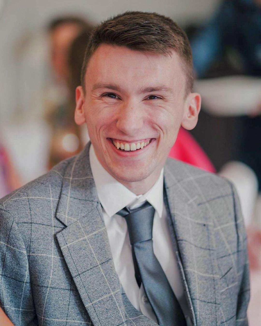 Wedding photographer in suit, laughing
