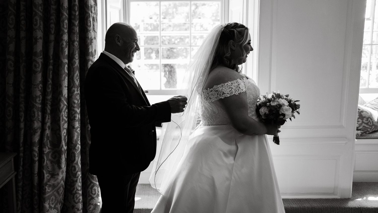 Father fixes bride's veil before the ceremony