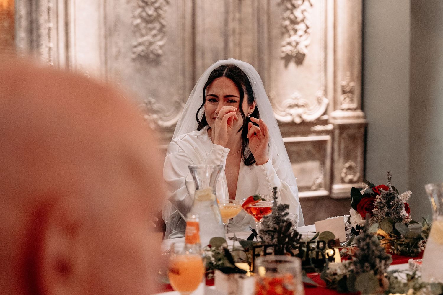 Bride wipes her eye as she cries during the speeches