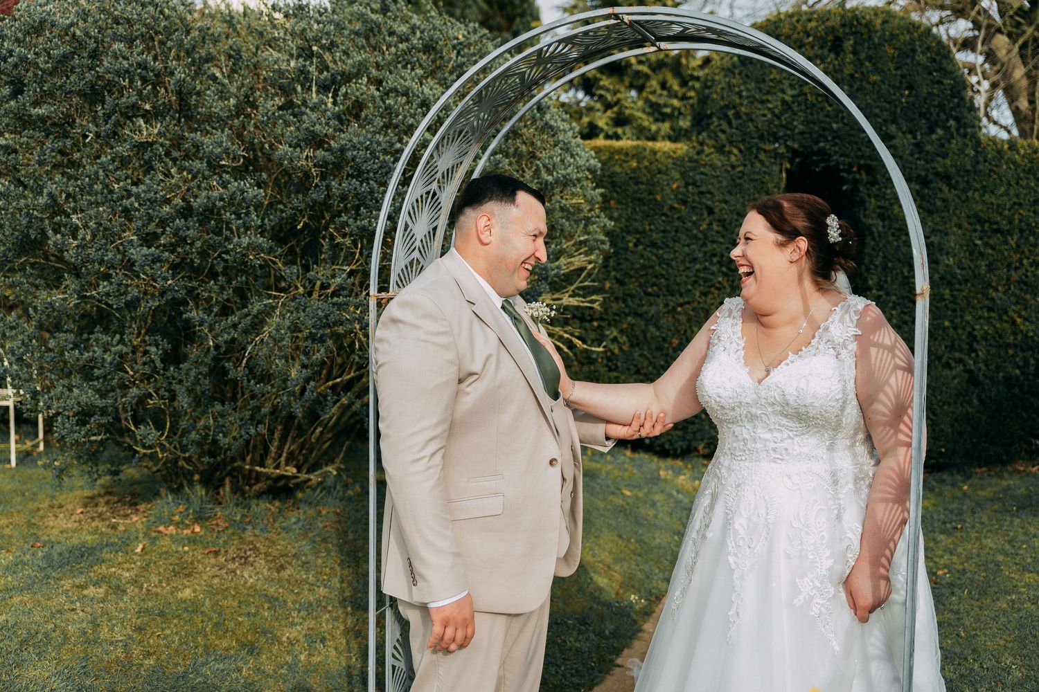Bride and groom laugh as they're playful with eachother