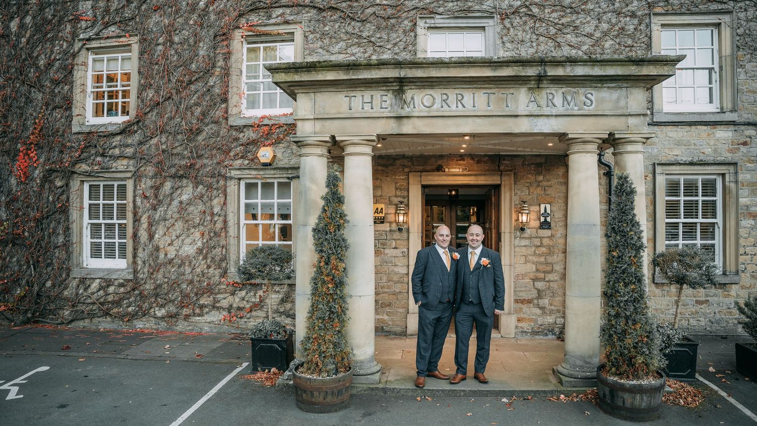 Newly-wed couple stand outside their wedding venue