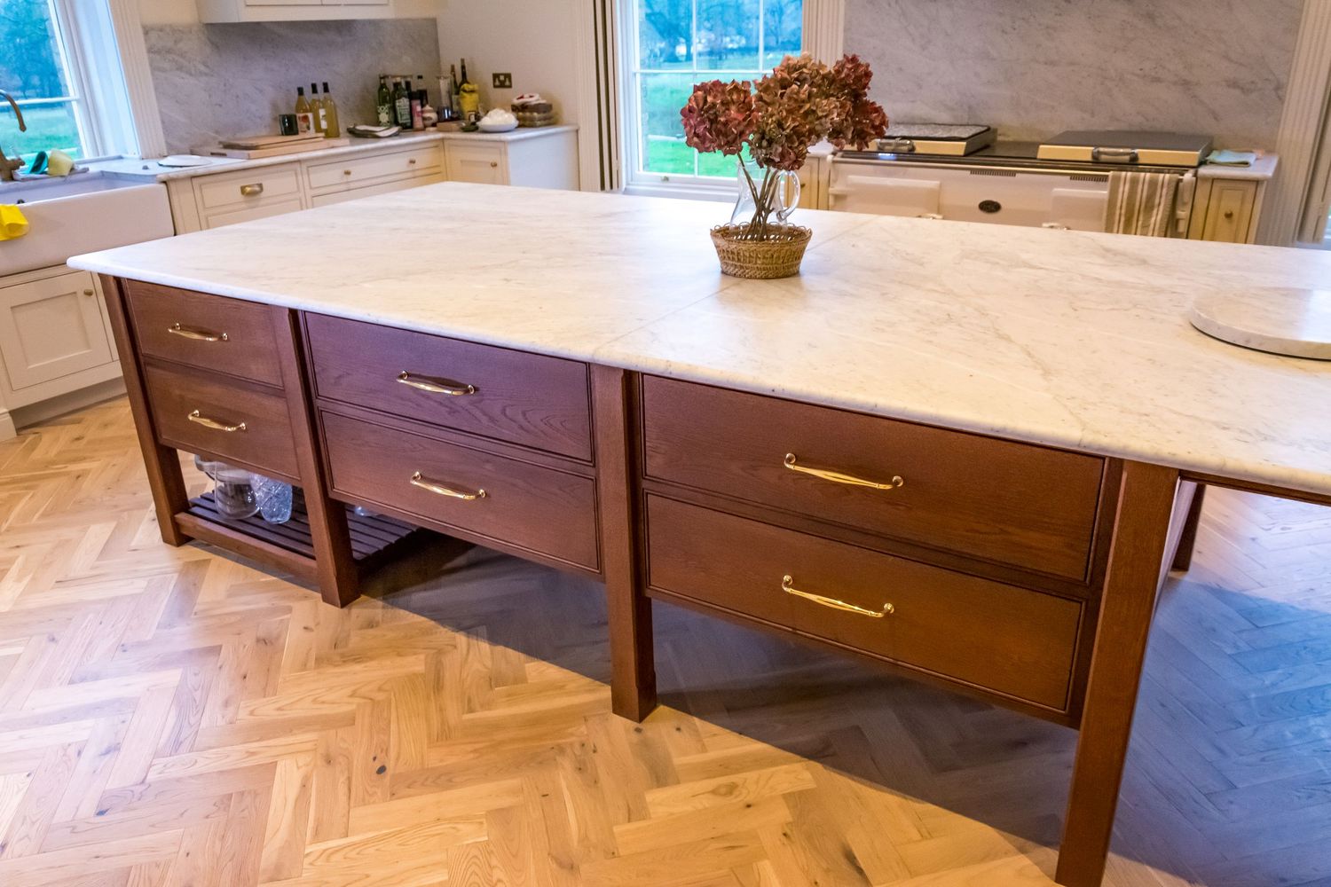 Kitchen island with marble countertop, walnut cabinets, and herringbone parquet floor. Commissioned woodwork photographed by Roddy.