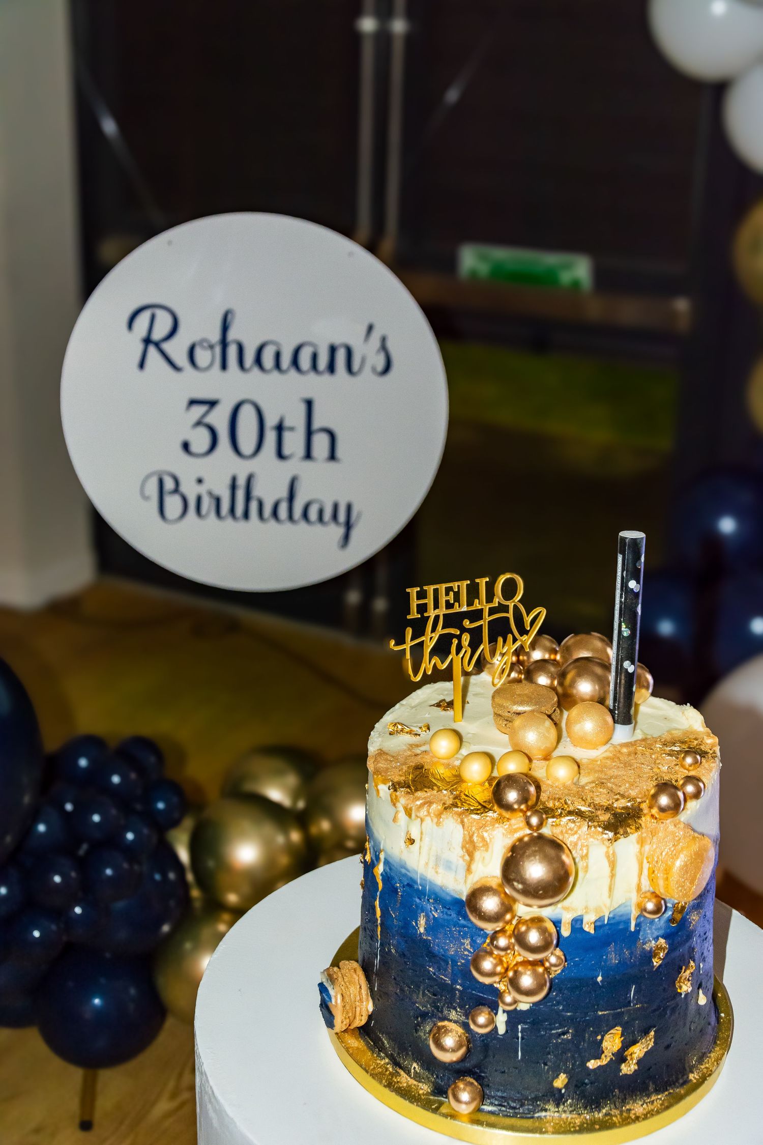 Elegant blue and gold 30th birthday cake with Hello Thirty topper for Rohaan's celebration.