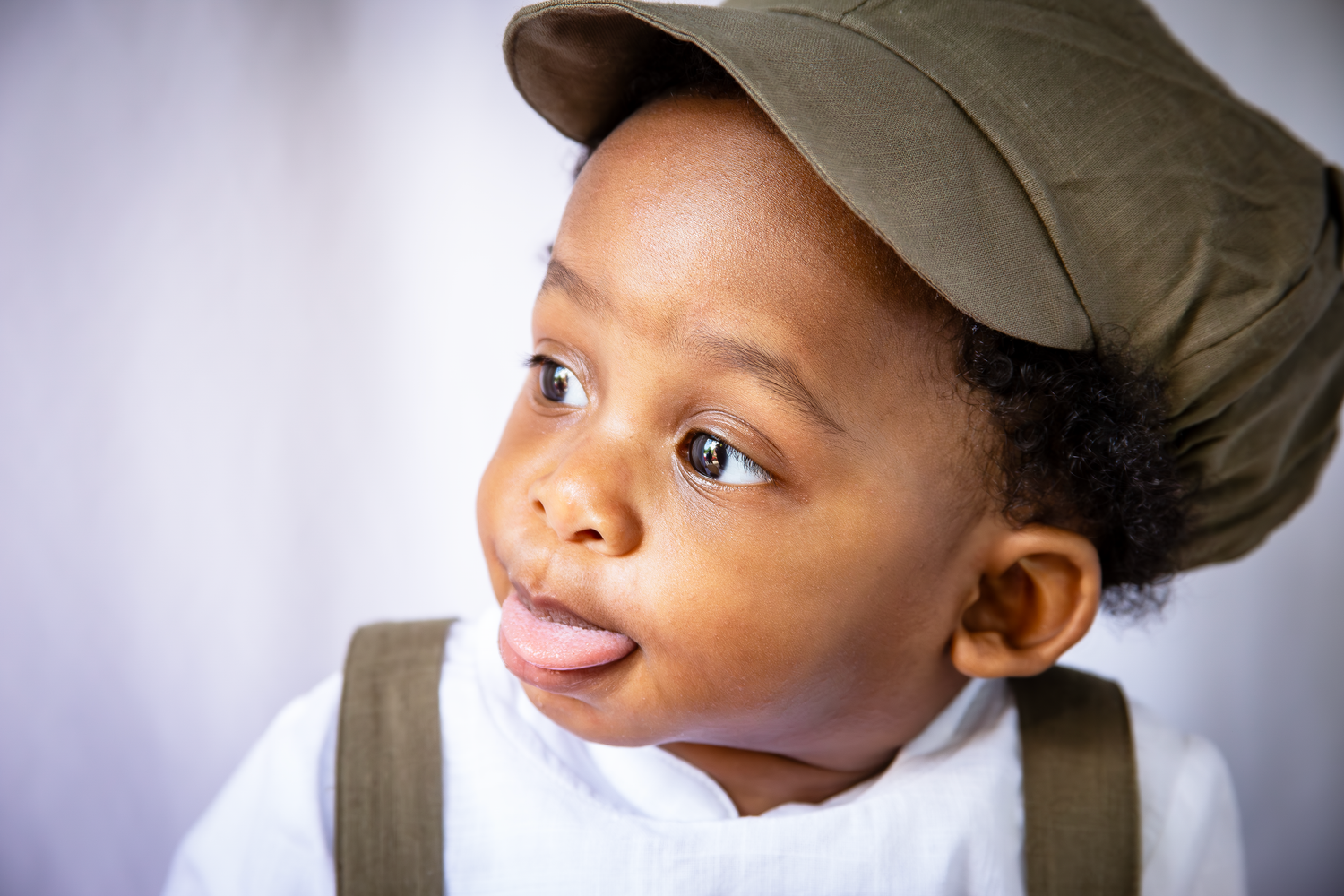 Adorable baby boy sticking out his tongue in a photoshoot done by Roddy Lloyd-Jones from LJPhotostop