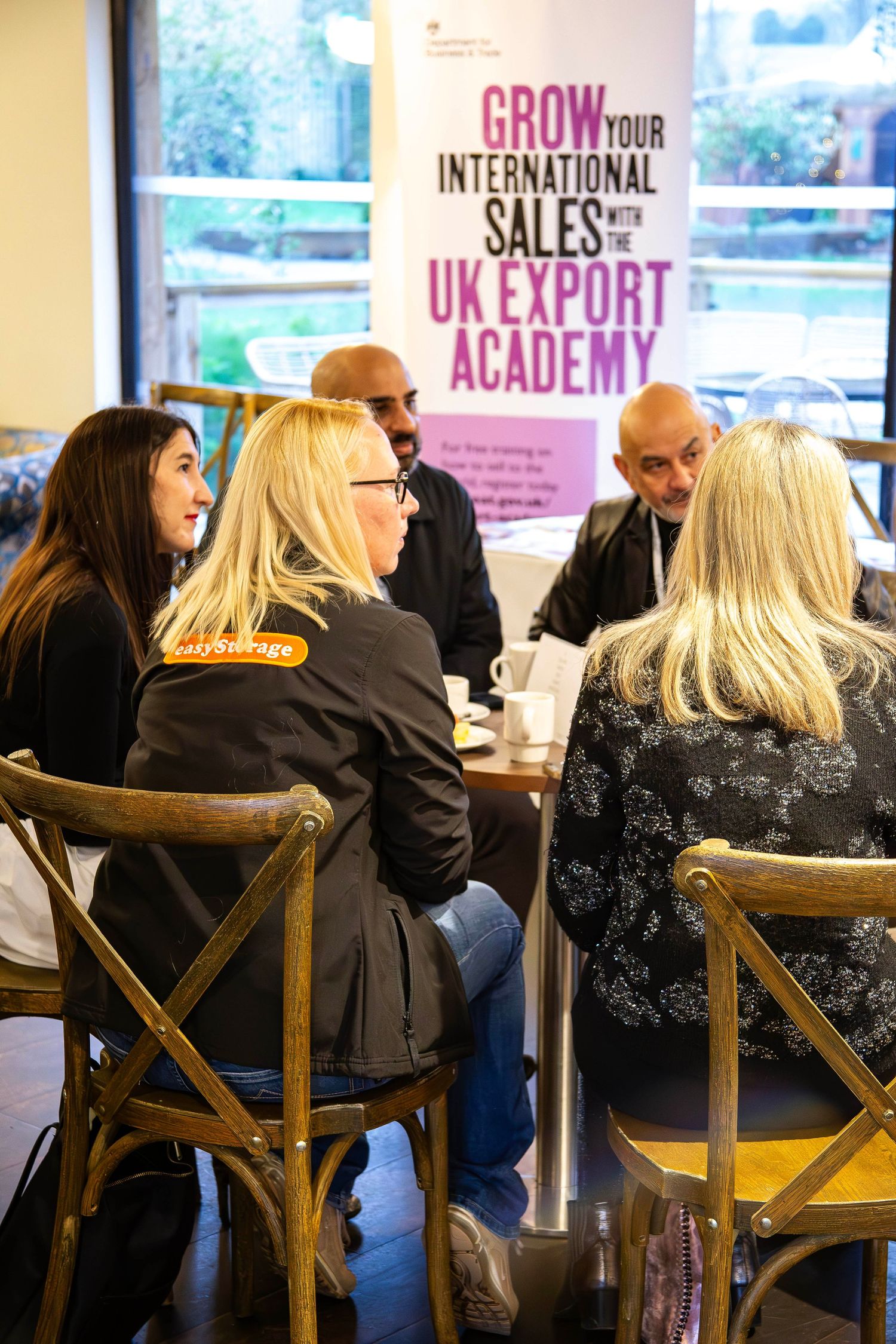 Business professionals networking at a UK Export Academy event to grow international sales.