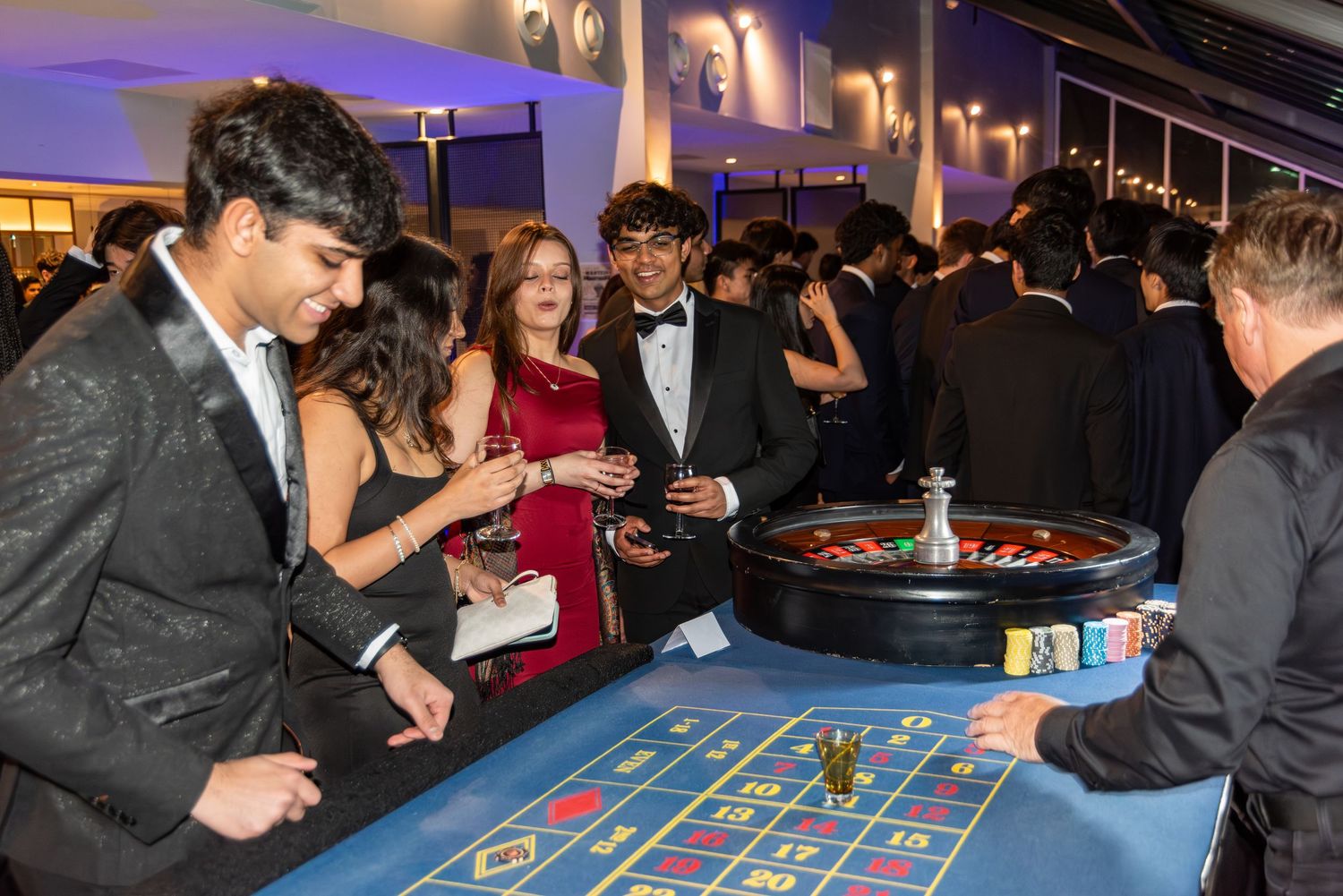 Young guests playing roulette at a casino-themed school event.