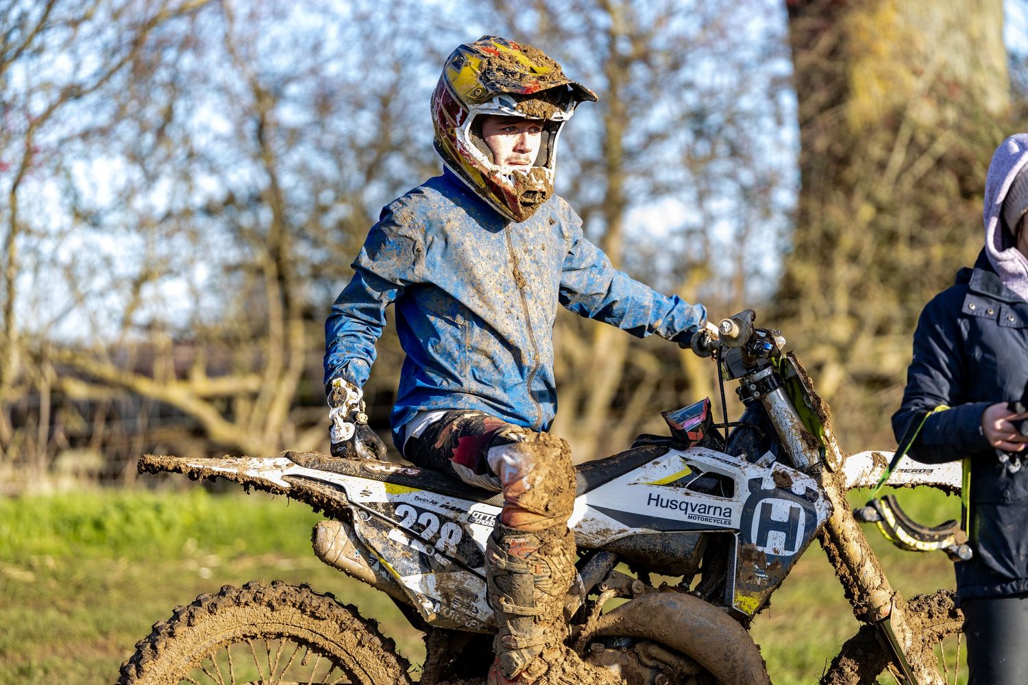 Young motocross rider on a muddy Husqvarna dirt bike. Photographed by Roddy from LJPhotostop.
