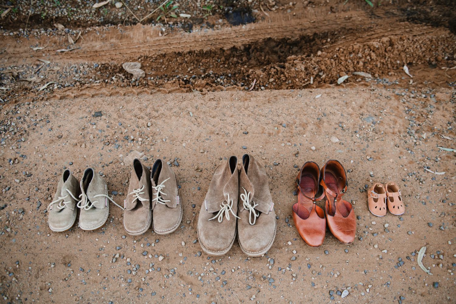 Creative composition of five sets of shoes representing the whole family during a maternity and family shoot.