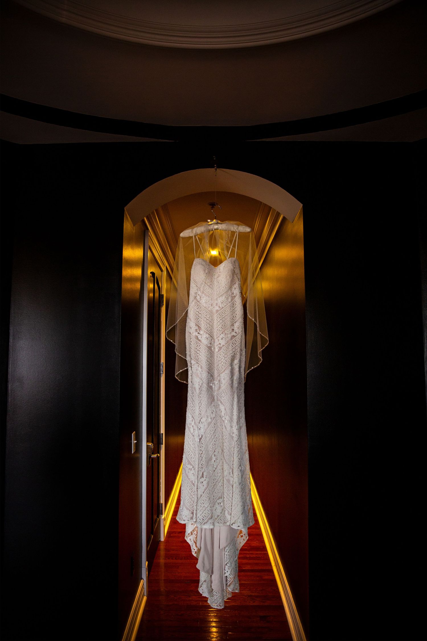 Professional portrait of the wedding dress hanging the morning of the wedding day.
