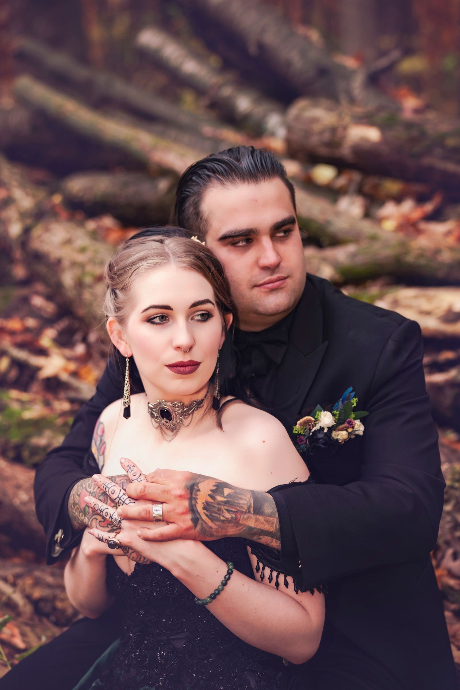 Bride in a black dress, held by a groom in a black suit for a natural, Michigan farm wedding.