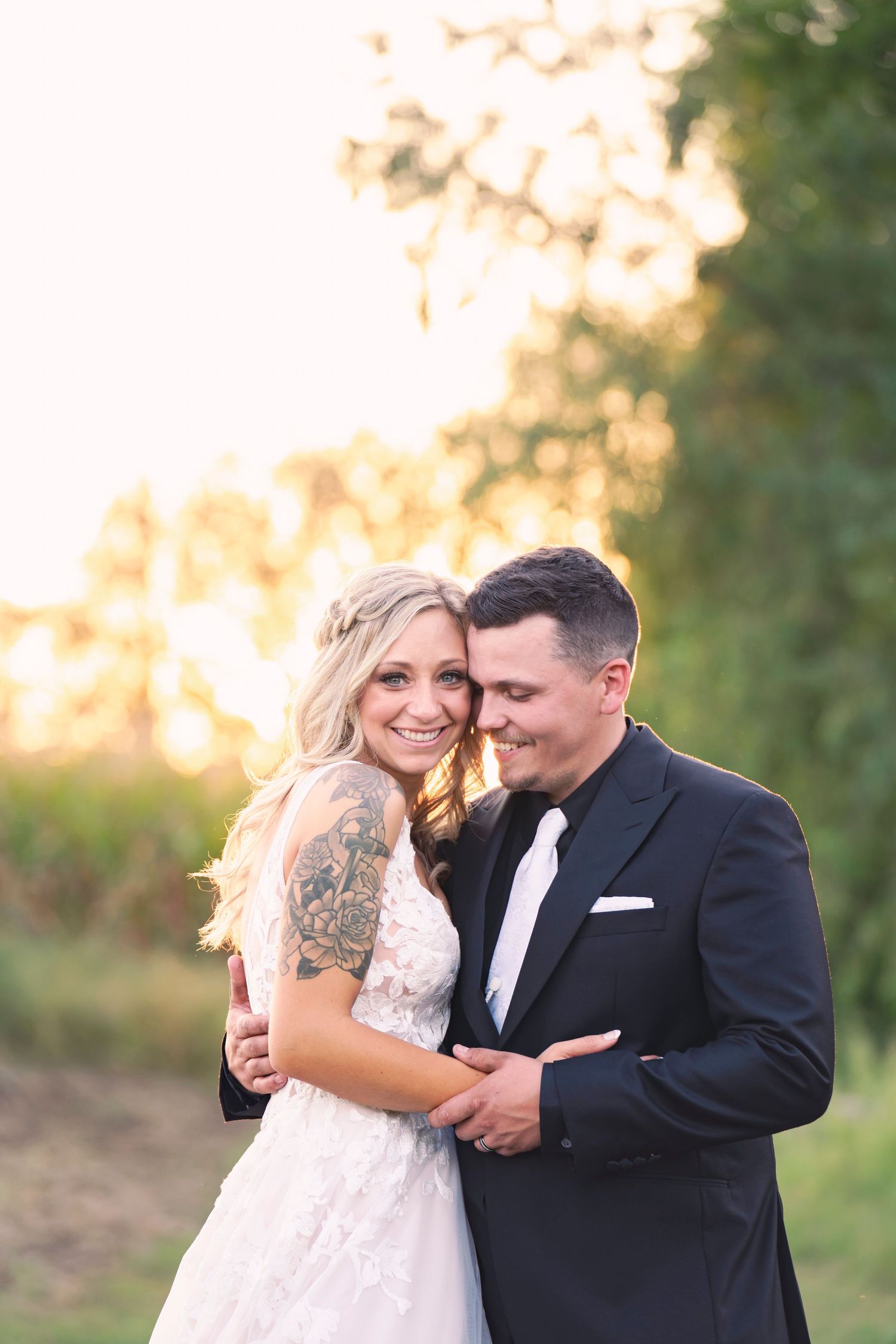 A golden hour wedding photo of a bride and groom on their wedding day.