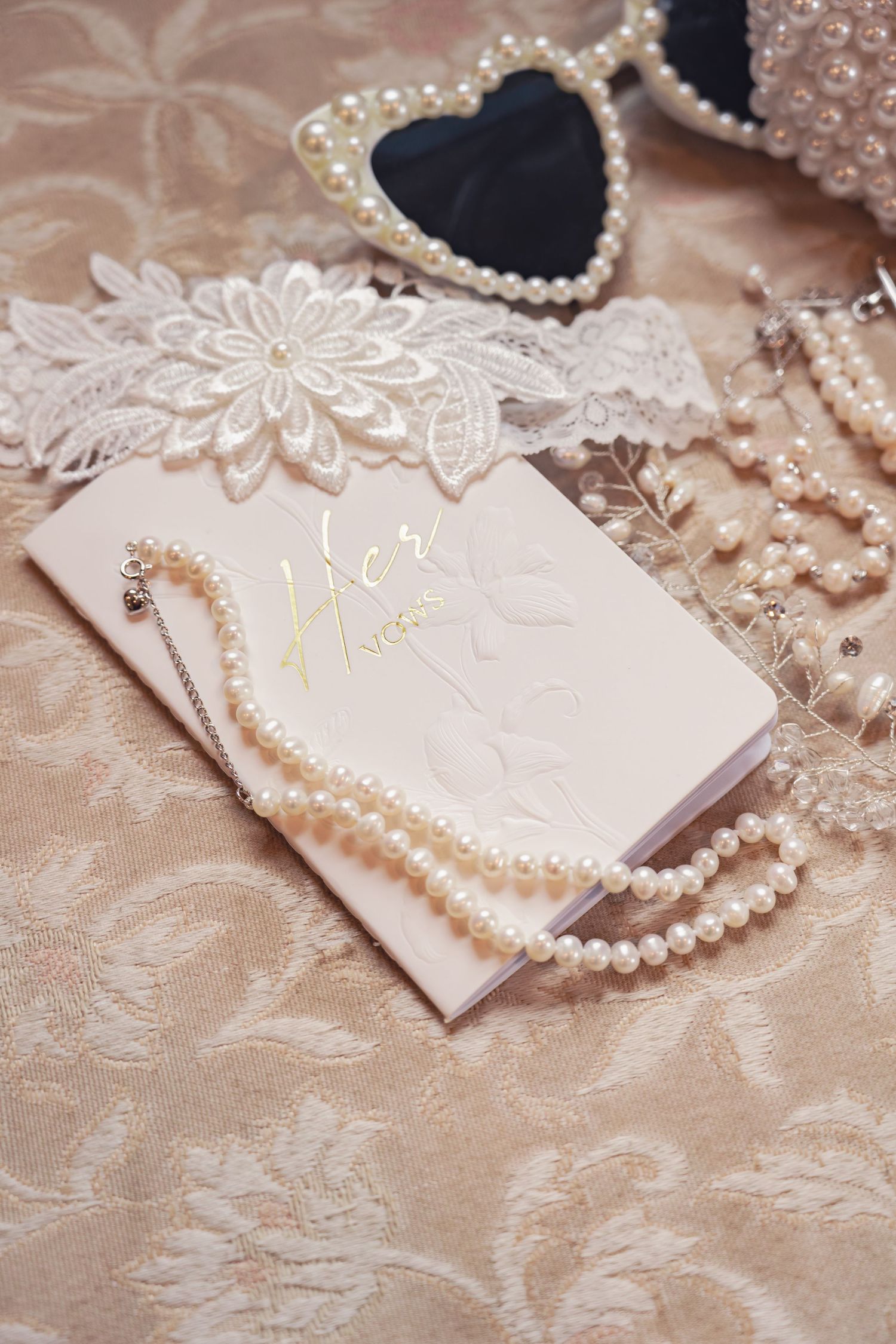 A messy still-life of bridal details including a 