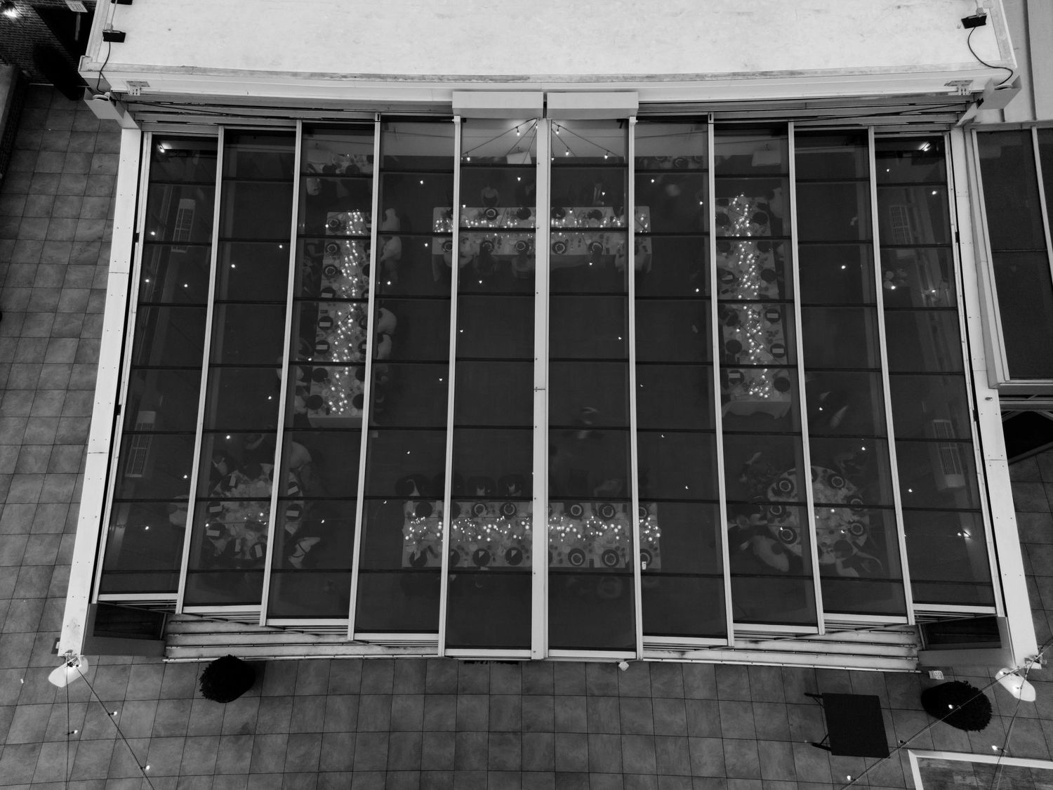 Black and white view of metal security bars mounted on an exterior window.