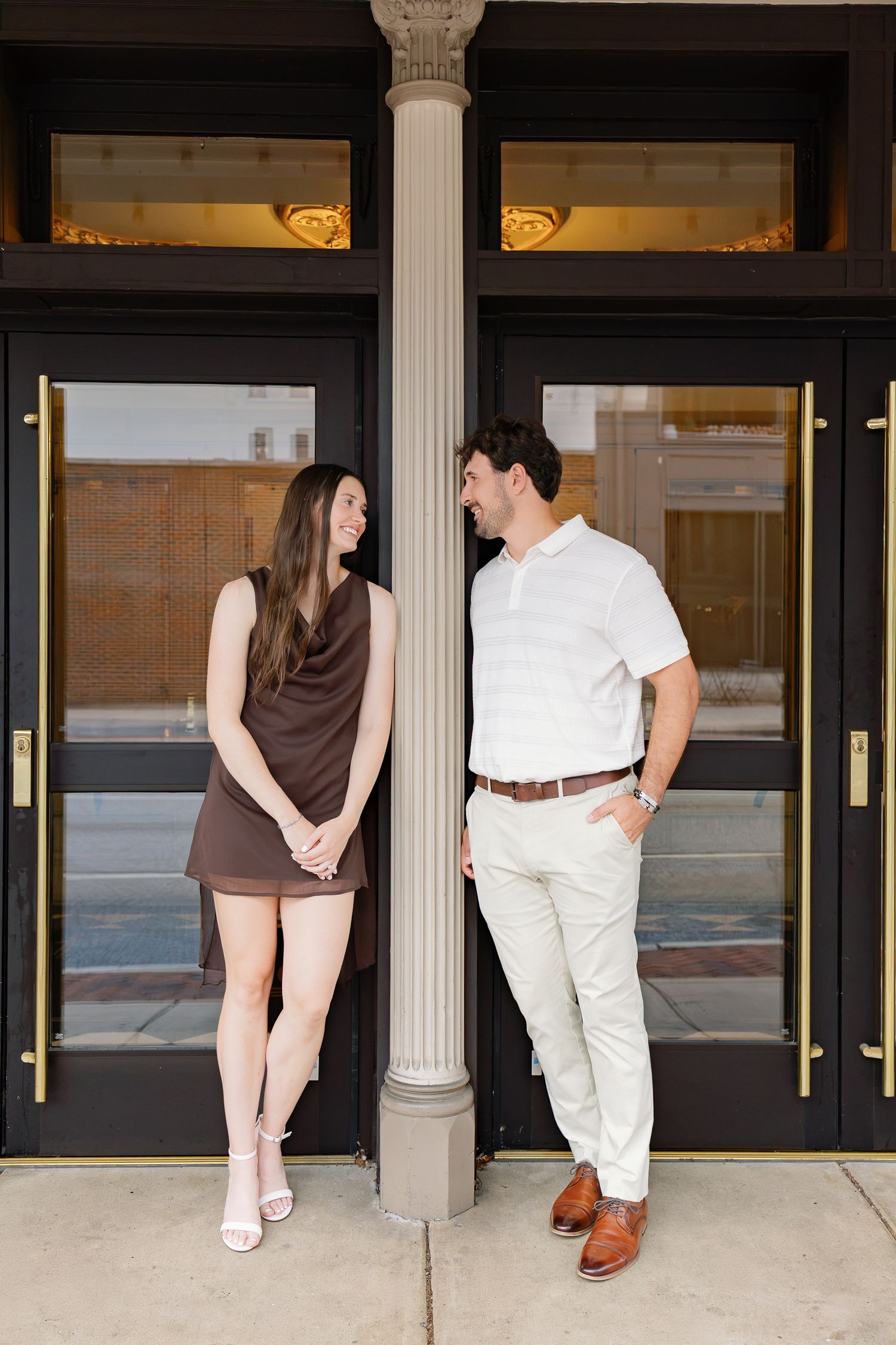 Engaged couple smiling together during their downtown Lancaster, Pennsylvania engagement photography session