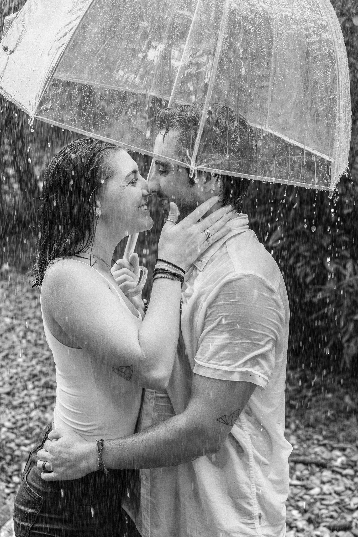 Couple kissing beneath an umbrella during a romantic outdoor couples photography session in York, Pennsylvania