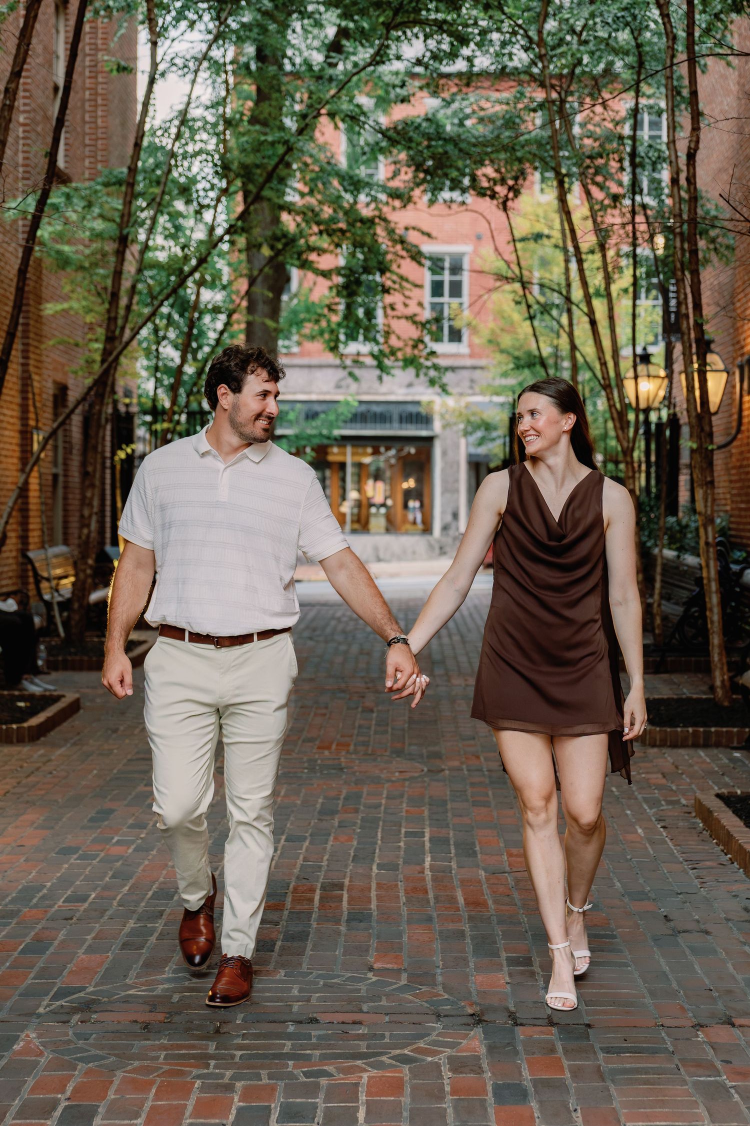Couple walking hand in hand through downtown Lancaster PA during a romantic couples photography session