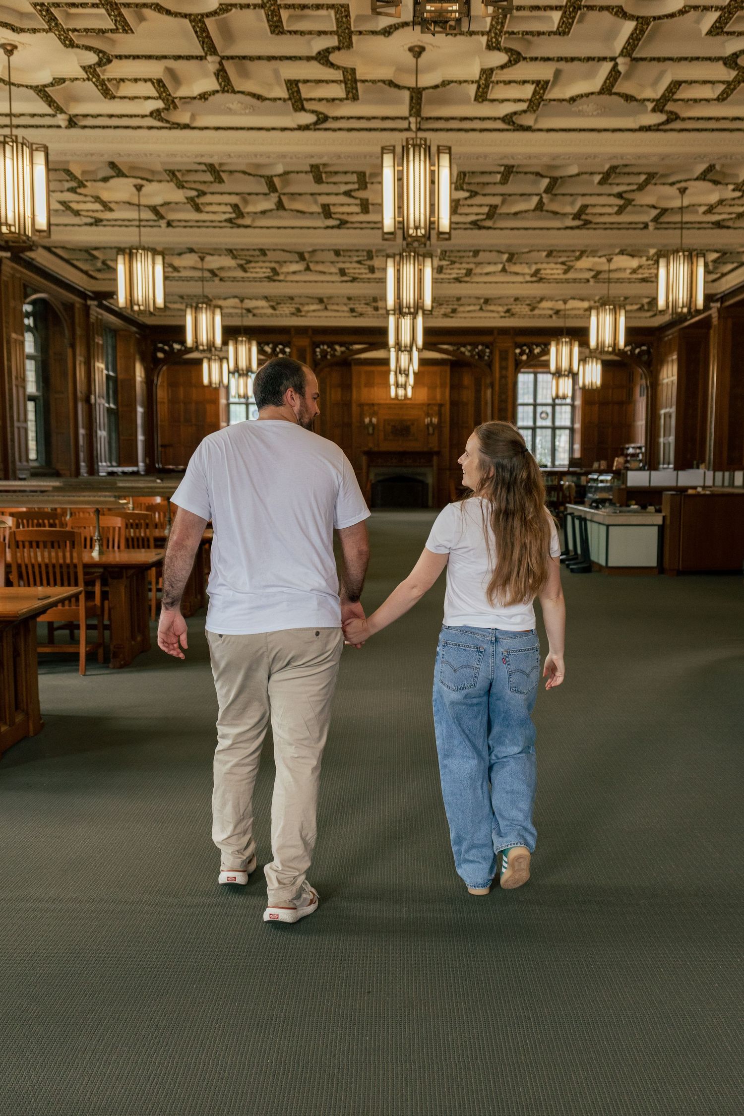 Couple walking hand in hand through historic Linderman Library during a couples photography session in Bethlehem PA