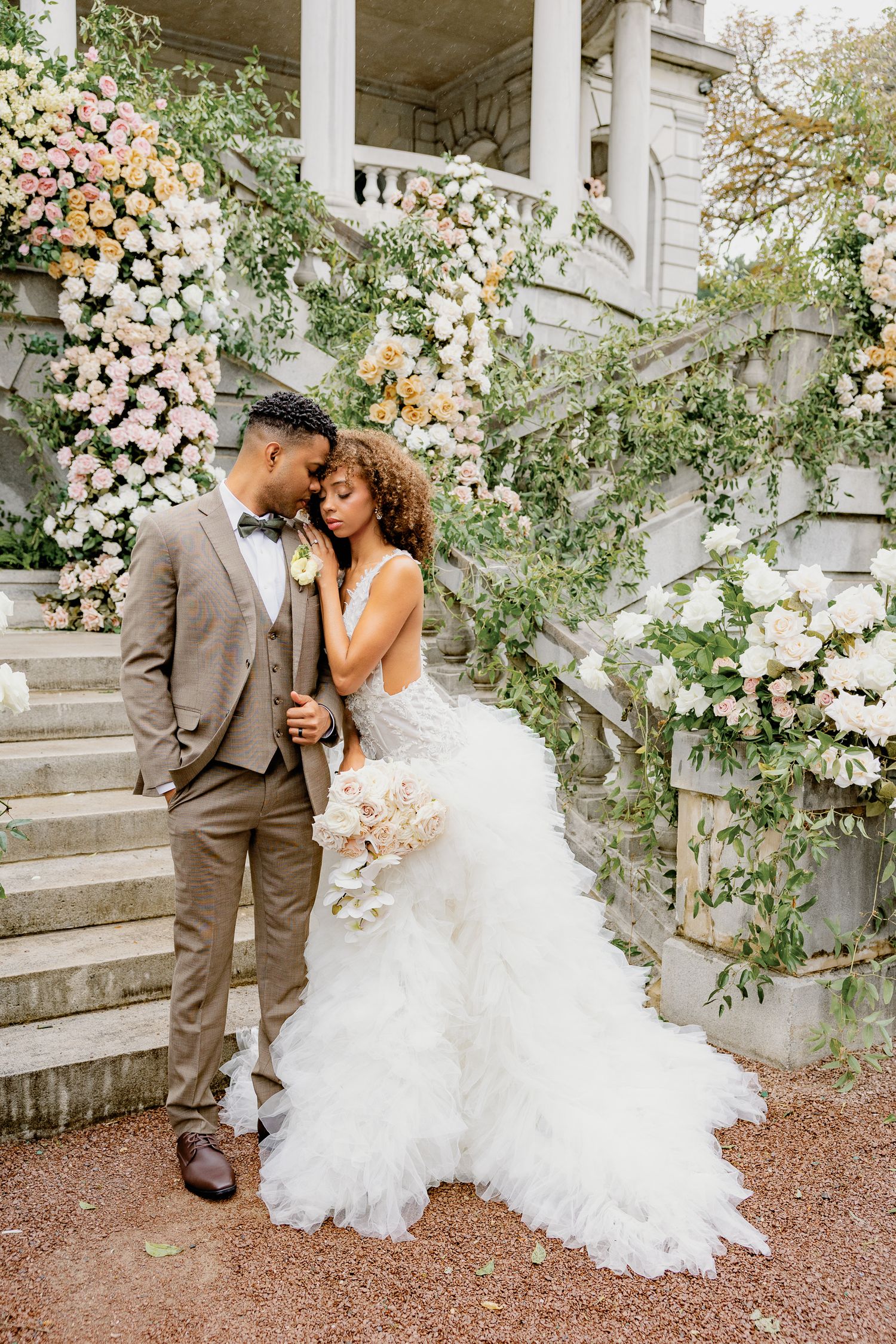Editorial bride and groom portrait with lush wedding florals at Elkins Estate in Elkins Park, Pennsylvania.