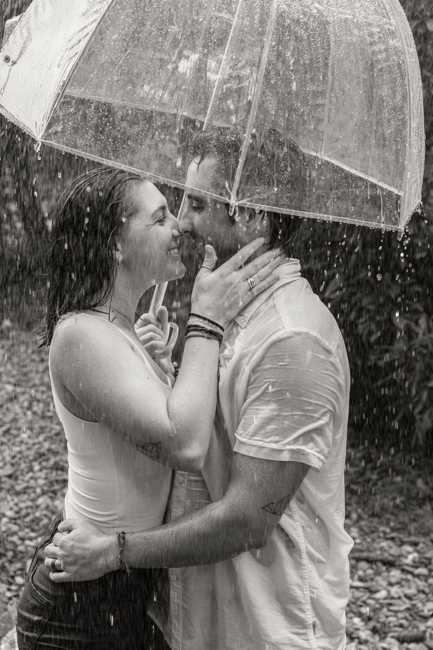 Black and white photo of a couple kissing under an umbrella during a romantic Pennsylvania couples photography session