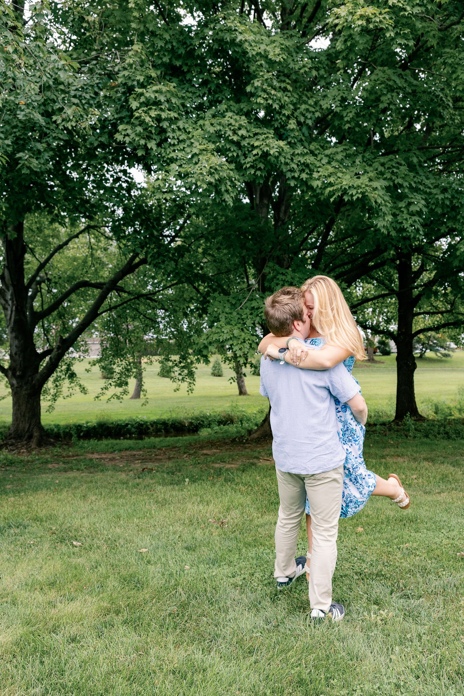 Couple embracing beneath the trees during an outdoor couples photography session at Greenfield Park in Lancaster, Pennsylvania