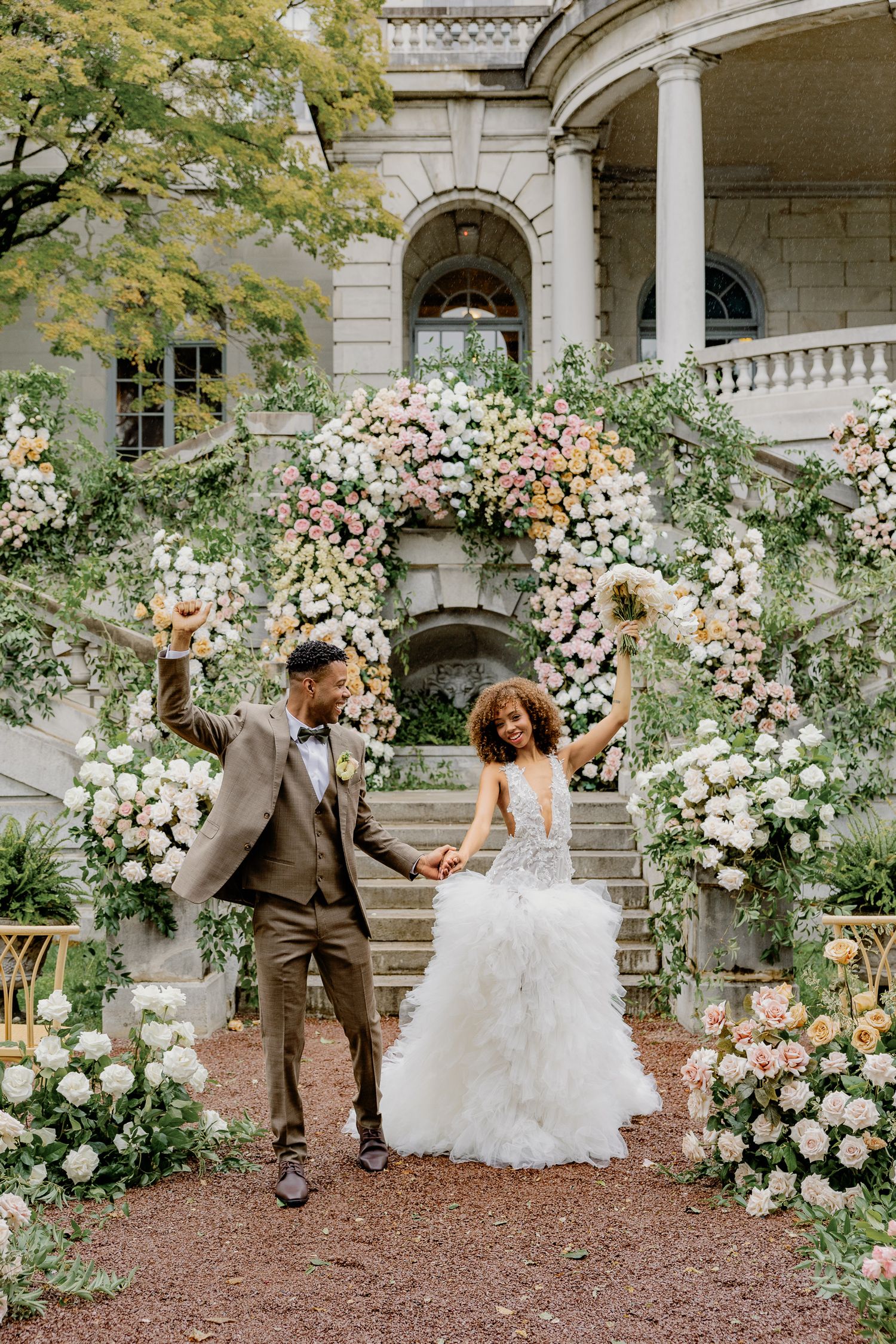 Bride and groom surrounded by lush florals at Elkins Estate, a historic wedding venue near Philadelphia, Pennsylvania.